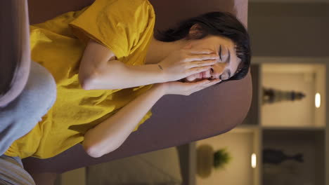 Vertical-video-of-Depressed-young-woman-covering-her-face-with-her-hand.